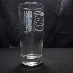 Beer glass engraved with the saying Turning Wrenches Tapping Kegs and the image of a wrench and a keg on it
