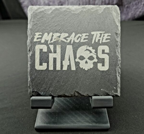 Natural Slate coaster engraved with the saying "Embrace the Chaos" utilizing our gearhead logo in the word Chaos.